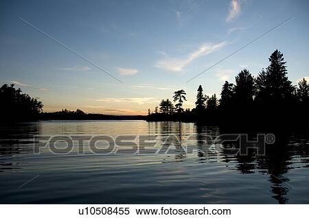 Lake of the Woods, Ontario, Canada; Sunset over placid lake View Large Photo Image Stock Photography - Lake of the Woods, Ontario, Canada; Sunset over placid lake. Fotosearch