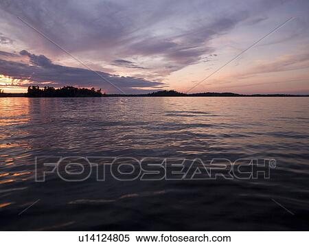 Stock Photography - Lake of the Woods, Ontario, Canada; Still lake water. Fotosearch