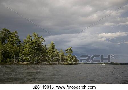 Stock Photography - Lake of the Woods, Ontario, Canada; View of woods next to a lake. Fotosearch