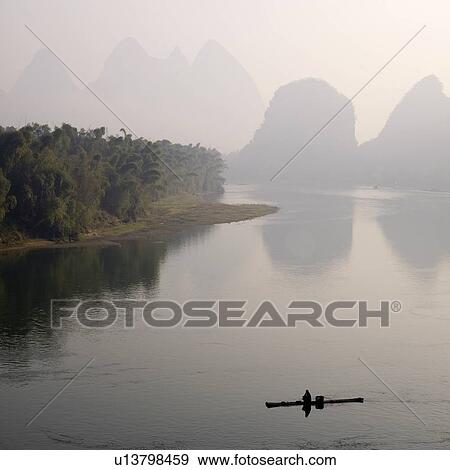 Li River, Yangshuo county, Guilin, Guangxi Province, China; lone boater View Large Photo Image Stock Photo - Li River, Yangshuo county, Guilin, Guangxi Province, China; lone boater. Fotosearch