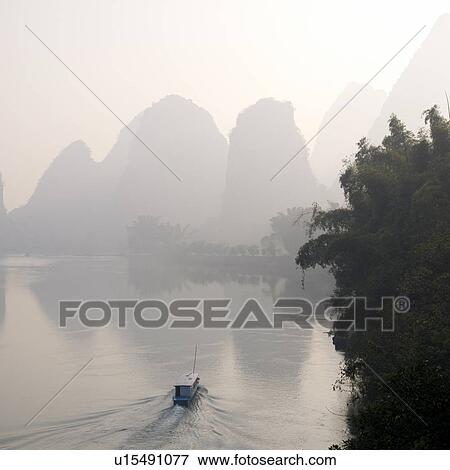 Stock Photo - Li river, Yangshuo, Guilin, Guangxi Province, China; Boat in the water. Fotosearch