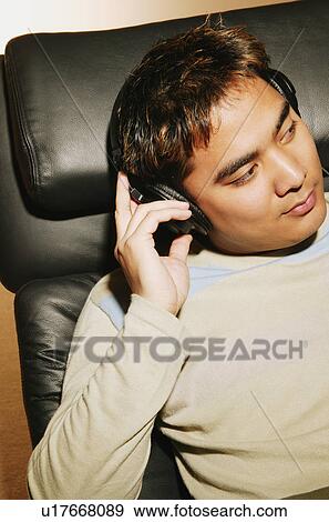 Listening to earphones View Large Photo Image Stock Photo - Listening to earphones. Fotosearch