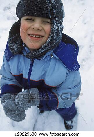 Stock Image - Little boy playing in the snow. Fotosearch