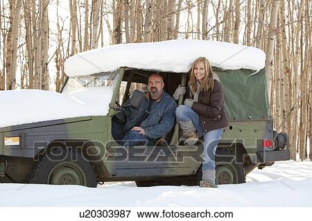 Man and woman in a snow covered vehicle View Large Photo Image Stock Photo - Man and woman in a snow covered vehicle. Fotosearch