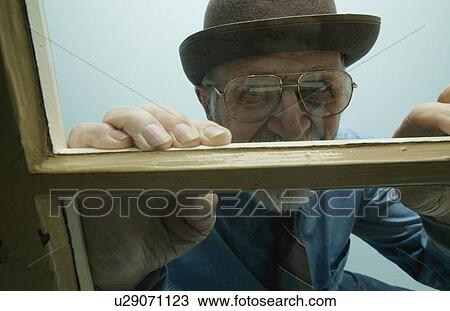 Man looks out window View Large Photo Image Stock Image - Man looks out window. Fotosearch