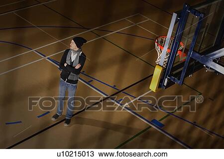 Man standing in basketball court View Large Photo Image Stock Image - Man standing in basketball court. Fotosearch