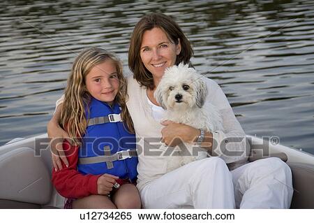 Mother and daughter with dog in boat, Lake of the Woods, Ontario, Canada View Large Photo Image Stock Photography - Mother and daughter with dog in boat, Lake of the Woods, Ontario, Canada. Fotosearch