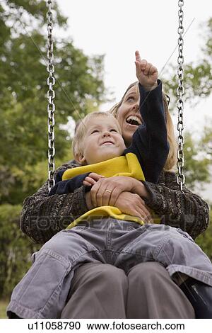 Mother and son on a swing View Large Photo Image Stock Image - Mother and son on a swing. Fotosearch