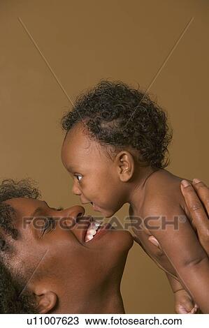 Mother holding baby View Large Photo Image Stock Image - Mother holding baby. Fotosearch