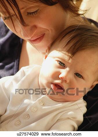 Mother holds baby View Large Photo Image Stock Photo - Mother holds baby. Fotosearch