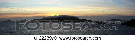 Stock Image - Near Dingle, Co Kerry, Ireland; Sunset over the Blasket Islands. Fotosearch