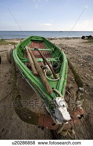 Stock Photo - Northumberland, England; Boat on a beach. Fotosearch