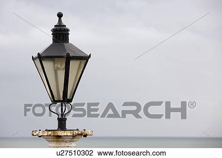 Stock Image - Old street light on the beachfront. Fotosearch