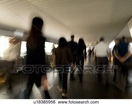 Stock Photograph - People walking through pedway. Fotosearch