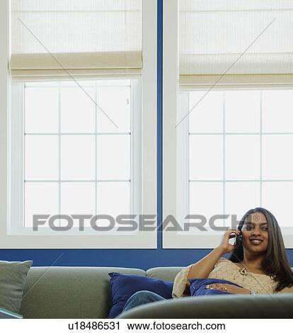 Phone call by the window View Large Photo Image Stock Image - Phone call by the window. Fotosearch