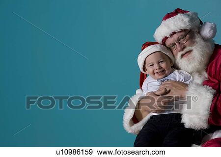 Stock Photo - Portrait of Santa with a baby. Fotosearch