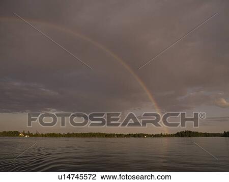 Rainbow over lake shoreline, Lake of the Woods, Ontario, Canada View Large Photo Image Stock Image - Rainbow over lake shoreline, Lake of the Woods, Ontario, Canada. Fotosearch