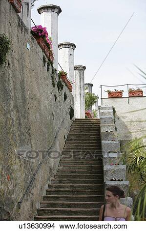 Picture - Ravello, Salerno, Campania, Italy; Woman standing at bottom of stairway. Fotosearch