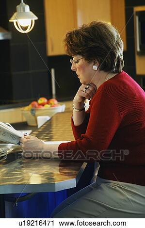 Reading the paper View Large Photo Image Stock Image - Reading the paper. Fotosearch