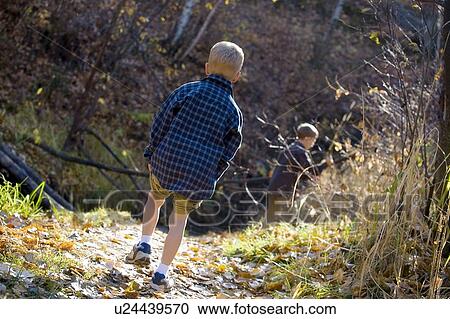 Rear view of boys hiking View Large Photo Image Stock Image - Rear view of boys hiking. Fotosearch