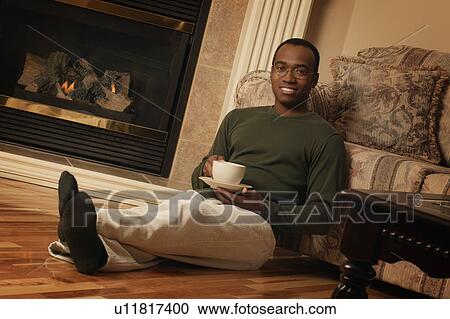 Relaxing by the fireplace View Large Photo Image Stock Image - Relaxing by the fireplace. Fotosearch
