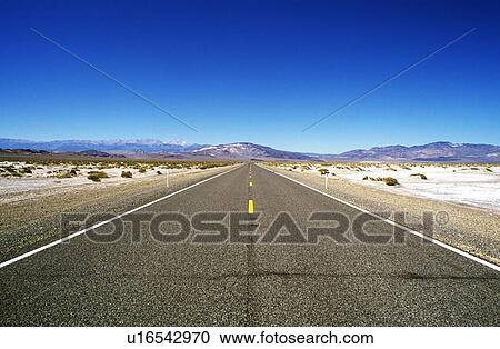 Road leading through barren landscape to mountains View Large Photo Image Stock Image - Road leading through barren landscape to mountains. Fotosearch