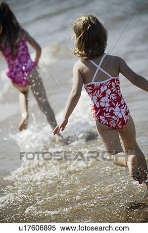 Stock Photography - Running along the beach. Fotosearch