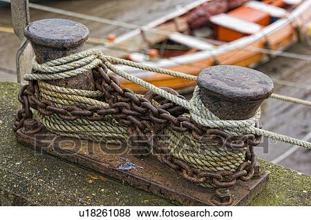 Stock Photo - Rusty chains around bollard. Fotosearch