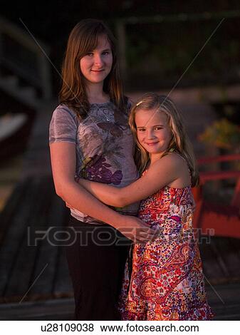 Stock Photo - Sisters embracing, Lake of the Woods, Ontario, Canada. Fotosearch