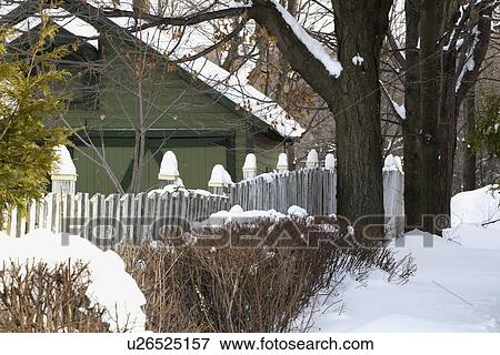 Stock Photo - Snow covered garden and barn. Fotosearch