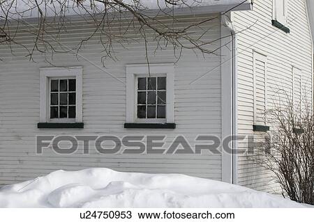 Stock Image - Snow piling high in a backyard. Fotosearch