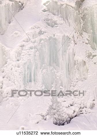 Stock Image - Snowy cliff, northern British Columbia, Canada. Fotosearch