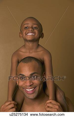 Picture - Son on father's shoulders. Fotosearch