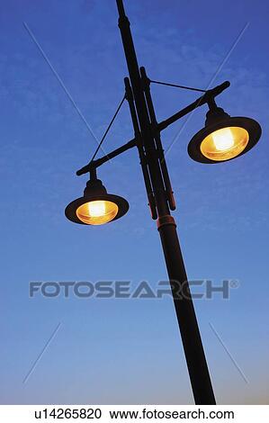 Street lamps against blue sky View Large Photo Image Stock Image - Street lamps against blue sky . Fotosearch