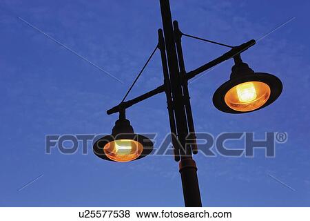 Street lamps against blue sky View Large Photo Image Stock Photo - Street lamps against blue sky . Fotosearch