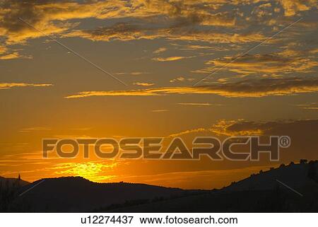 Stock Photo - Sunset over landscape. Fotosearch