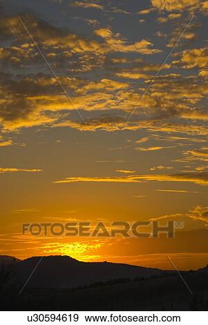 Stock Photo - Sunset over landscape. Fotosearch