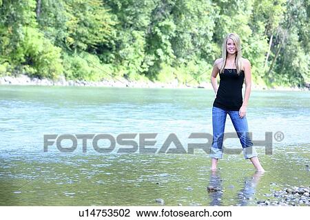 Teen girl standing in stream View Large Photo Image Stock Image - Teen girl standing in stream. Fotosearch