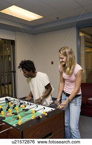 Teenagers playing foosball View Large Photo Image Stock Photograph - Teenagers playing foosball. Fotosearch