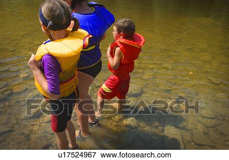 Stock Photo - Three children paddling in a lake. Fotosearch