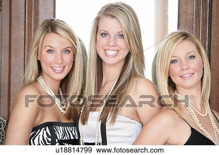 Stock Photo - Three teenage girls in formal wear. Fotosearch