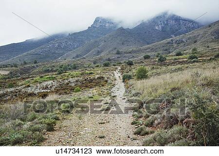 Stock Image - Trail near Torremolinos, Malaga Province, Spain; country trail on side of mountain. Fotosearch