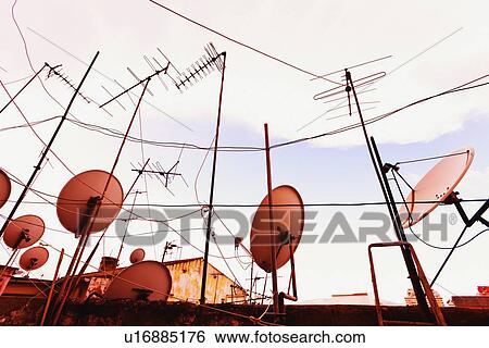 TV aerials and satellite dishes; TV aerials and satellite dishes View Large Photo Image Stock Photograph - TV aerials and satellite dishes; TV aerials and satellite dishes. Fotosearch