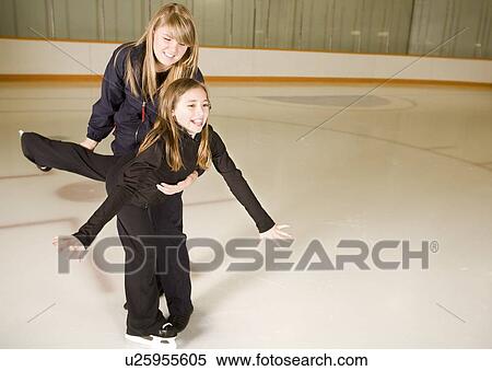 Two girls practicing ice skating together View Large Photo Image Stock Photography - Two girls practicing ice skating together. Fotosearch