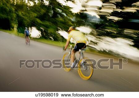 Stock Photo - Two people on bikes. Fotosearch
