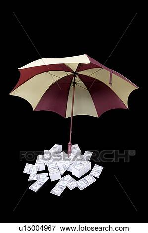Stock Photo - Umbrella covering piles of money. Fotosearch