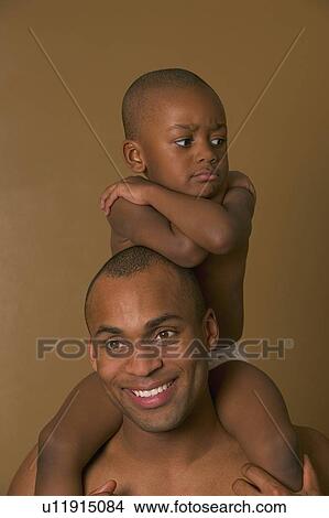 Upset son on father's shoulders View Large Photo Image Picture - Upset son on father's shoulders. Fotosearch