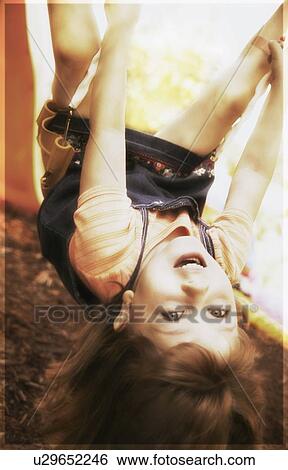 Upside down on a swing View Large Photo Image Stock Photograph - Upside down on a swing. Fotosearch