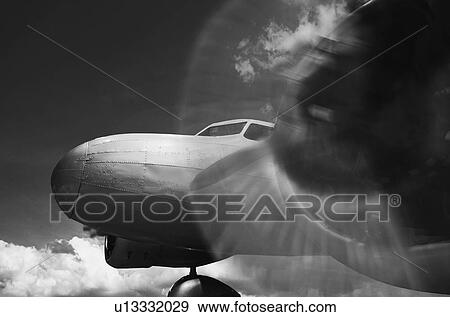 Vintage twin engine airplane with propeller rotating in black and white View Large Photo Image Stock Photo - Vintage twin engine airplane with propeller rotating in black and white. Fotosearch