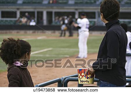 Watching a baseball game View Large Photo Image Stock Photo - Watching a baseball game. Fotosearch